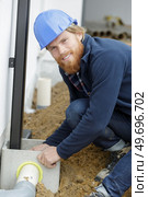 home renovation plumber fixing sewerage pipe at construction site. Стоковое фото, агентство Ingram Publishing / Фотобанк Лори