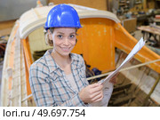 female working at a boat workshop. Стоковое фото, агентство Ingram Publishing / Фотобанк Лори