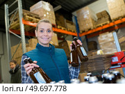portrait of female worker holding bottles of beer. Стоковое фото, агентство Ingram Publishing / Фотобанк Лори