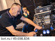 sound engineers seting up equipment. Стоковое фото, агентство Ingram Publishing / Фотобанк Лори