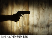 Тень руки с пистолетом. Стоковое AI-изображение, AI-художник Александр Жуков / Фотобанк Лори