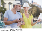 mature woman holding map man stressing the time restrictions. Стоковое фото, агентство Ingram Publishing / Фотобанк Лори