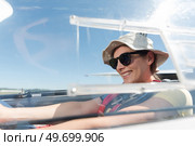 an excited woman in sail plane. Стоковое фото, агентство Ingram Publishing / Фотобанк Лори