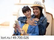 two happy women hugging and looking at the map. Стоковое фото, агентство Ingram Publishing / Фотобанк Лори