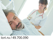 sad man in bed in hospital feeling ill. Стоковое фото, агентство Ingram Publishing / Фотобанк Лори
