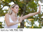 serene woman practising tai chi. Стоковое фото, агентство Ingram Publishing / Фотобанк Лори