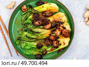 Chinese fried Pak Choi with shitake mushrooms. Asian vegan food. Fried chinese cabbage pak choi. Стоковое фото, агентство Ingram Publishing / Фотобанк Лори