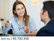 smiling femalee doctor showing glasses and contact lens. Стоковое фото, агентство Ingram Publishing / Фотобанк Лори