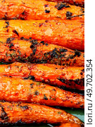 Roasted whole carrots, healthy root vegetables. Food background. Appetizing baked carrots, close up. Стоковое фото, агентство Ingram Publishing / Фотобанк Лори
