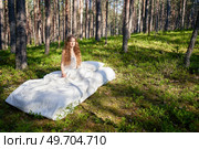 Woman sleeps on a mattress in the summer forest. The girl is resting in nature. Стоковое фото, агентство Ingram Publishing / Фотобанк Лори