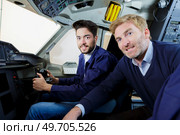 portrait of two pilots flying jet airliner. Стоковое фото, агентство Ingram Publishing / Фотобанк Лори