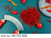 Spicy seasoning, spice, cut from red pepper. Thinly sliced pepper. Condiment. Cutting red chilly peppers. Стоковое фото, агентство Ingram Publishing / Фотобанк Лори