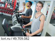 young people training on exercise bikes in gym. Стоковое фото, агентство Ingram Publishing / Фотобанк Лори