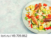 Delicious salad of fresh vegetables, herbs and fried octopus tentacles. Appetizing seafood salad. Стоковое фото, агентство Ingram Publishing / Фотобанк Лори