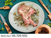 Raw pork steak Tomahawk marinated with spicy herbs for grilling. Fresh meat.. Raw barbecue Tomahawk steak. Стоковое фото, агентство Ingram Publishing / Фотобанк Лори