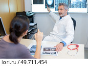 a radiologist pointing to images. Стоковое фото, агентство Ingram Publishing / Фотобанк Лори