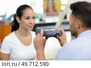 optician preparing to use handheld device to test clients vision. Стоковое фото, агентство Ingram Publishing / Фотобанк Лори