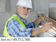 a senior male builder foreman. Стоковое фото, агентство Ingram Publishing / Фотобанк Лори