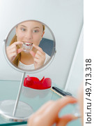 Woman inserting a mouth guard. Стоковое фото, агентство Ingram Publishing / Фотобанк Лори