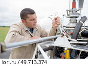 mechanic working on an aircraft outdoors on an airfield. Стоковое фото, агентство Ingram Publishing / Фотобанк Лори