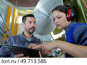 engineers checking a parabolic dish television antennae. Стоковое фото, агентство Ingram Publishing / Фотобанк Лори