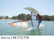salior trying to right his catamaran after capsize. Стоковое фото, агентство Ingram Publishing / Фотобанк Лори
