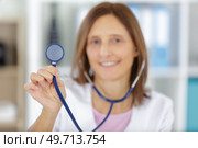 a lady doctor is holding a stethoscope. Стоковое фото, агентство Ingram Publishing / Фотобанк Лори