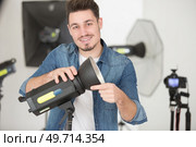 young male photographer in studio. Стоковое фото, агентство Ingram Publishing / Фотобанк Лори