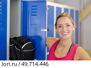 portrait of beautiful woman at her locker in sports center. Стоковое фото, агентство Ingram Publishing / Фотобанк Лори