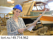 she is studying the boats blueprint. Стоковое фото, агентство Ingram Publishing / Фотобанк Лори