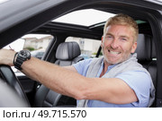 happy man smiling seated in his car holding the key. Стоковое фото, агентство Ingram Publishing / Фотобанк Лори
