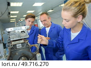 a woman adjusting the machinery. Стоковое фото, агентство Ingram Publishing / Фотобанк Лори