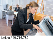 a woman is using photocopier. Стоковое фото, агентство Ingram Publishing / Фотобанк Лори