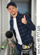 worker with gripper in hand is fixing a pipe. Стоковое фото, агентство Ingram Publishing / Фотобанк Лори