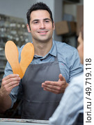 happy shoe worker holding shoes soles. Стоковое фото, агентство Ingram Publishing / Фотобанк Лори