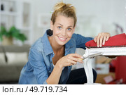 woman sculpting shape on wooden chair. Стоковое фото, агентство Ingram Publishing / Фотобанк Лори