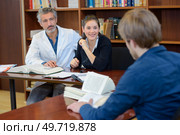 medicine student taking final exam with panel of professionals. Стоковое фото, агентство Ingram Publishing / Фотобанк Лори