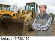 man posing next to the backhoe. Стоковое фото, агентство Ingram Publishing / Фотобанк Лори