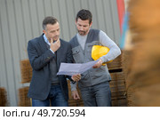 business managar and worker with factory plans outdoors. Стоковое фото, агентство Ingram Publishing / Фотобанк Лори