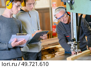 men are on a woodwork apprenticeship. Стоковое фото, агентство Ingram Publishing / Фотобанк Лори