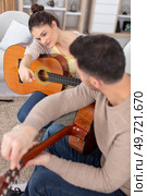 a man plays guitar for a beautiful woman. Стоковое фото, агентство Ingram Publishing / Фотобанк Лори