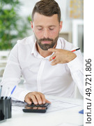 accountant calculating dollars with calculator in office. Стоковое фото, агентство Ingram Publishing / Фотобанк Лори