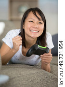 happy woman playing online won a video game competition. Стоковое фото, агентство Ingram Publishing / Фотобанк Лори