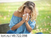 woman with with allergy symptom blowing nose. Стоковое фото, агентство Ingram Publishing / Фотобанк Лори