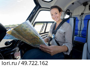 young woman helicopter pilot checking a map. Стоковое фото, агентство Ingram Publishing / Фотобанк Лори