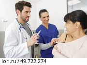 male doctor injects a senior patient. Стоковое фото, агентство Ingram Publishing / Фотобанк Лори