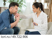 psychotherapist working with young man in office. Стоковое фото, агентство Ingram Publishing / Фотобанк Лори