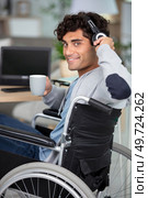 disabled man listening to music in wheelchair. Стоковое фото, агентство Ingram Publishing / Фотобанк Лори