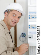 an electromechanic near distribution fuseboard. Стоковое фото, агентство Ingram Publishing / Фотобанк Лори