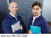 two engineers looking at camera. Стоковое фото, агентство Ingram Publishing / Фотобанк Лори